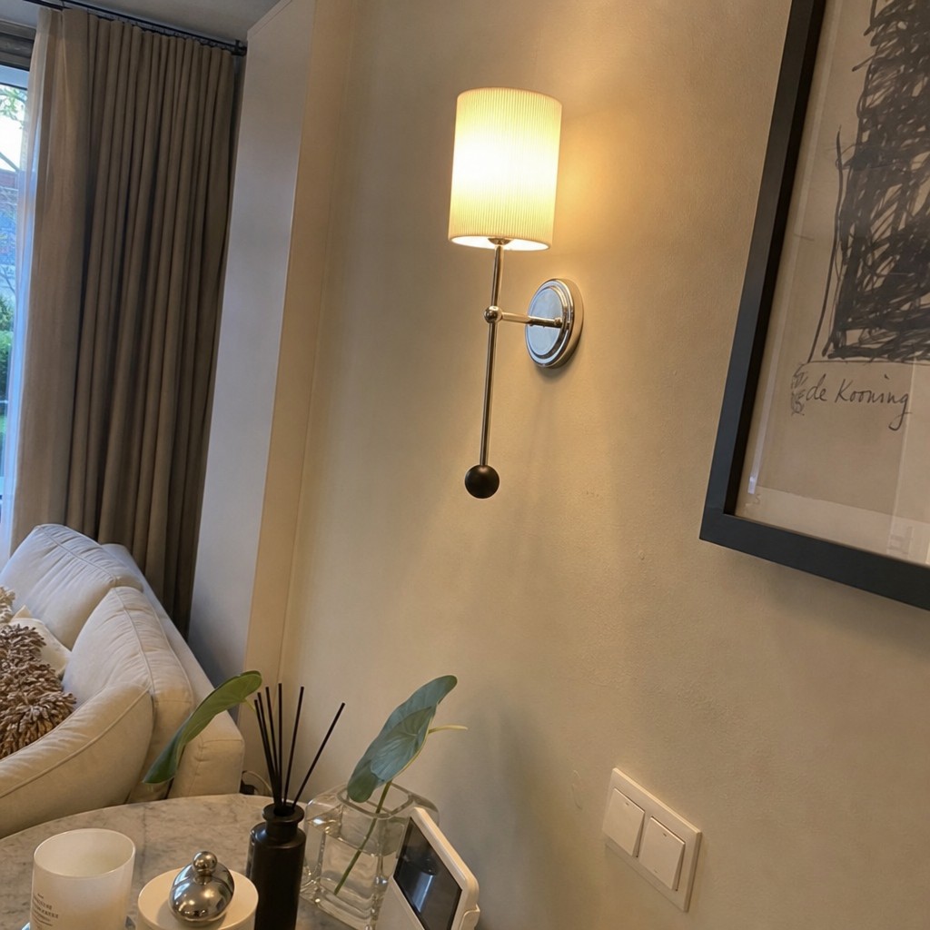 Customer photo of the Cumoris wall lamp beside a sofa