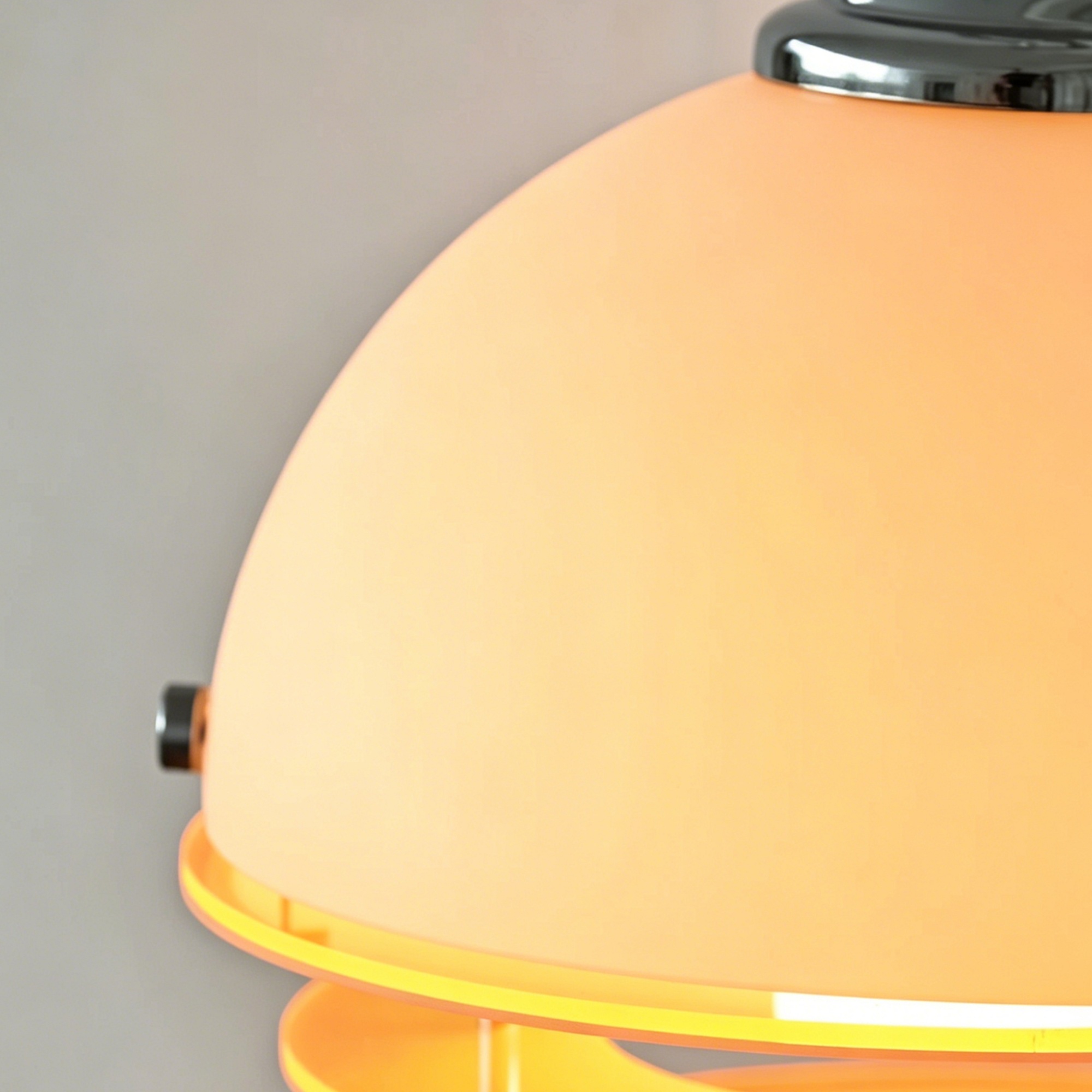 Close detail of the white and orange acrylic wall lamp shade