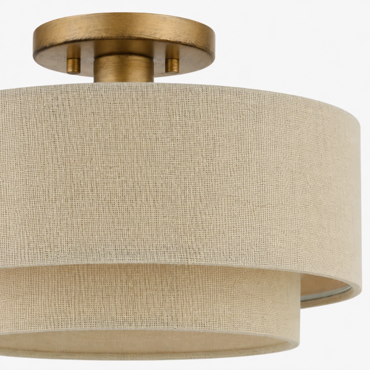 Close-up of the Lumeris linen blend shade and gold-finished ceiling light detail