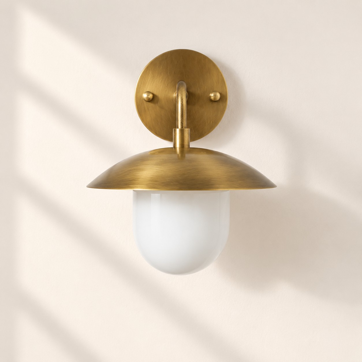 Frosted White Glass Globe — Brass-Finish Wall Sconce — A natural perspective