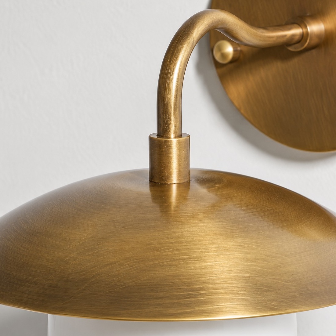 Frosted White Glass Globe — Brass-Finish Wall Sconce — A natural perspective