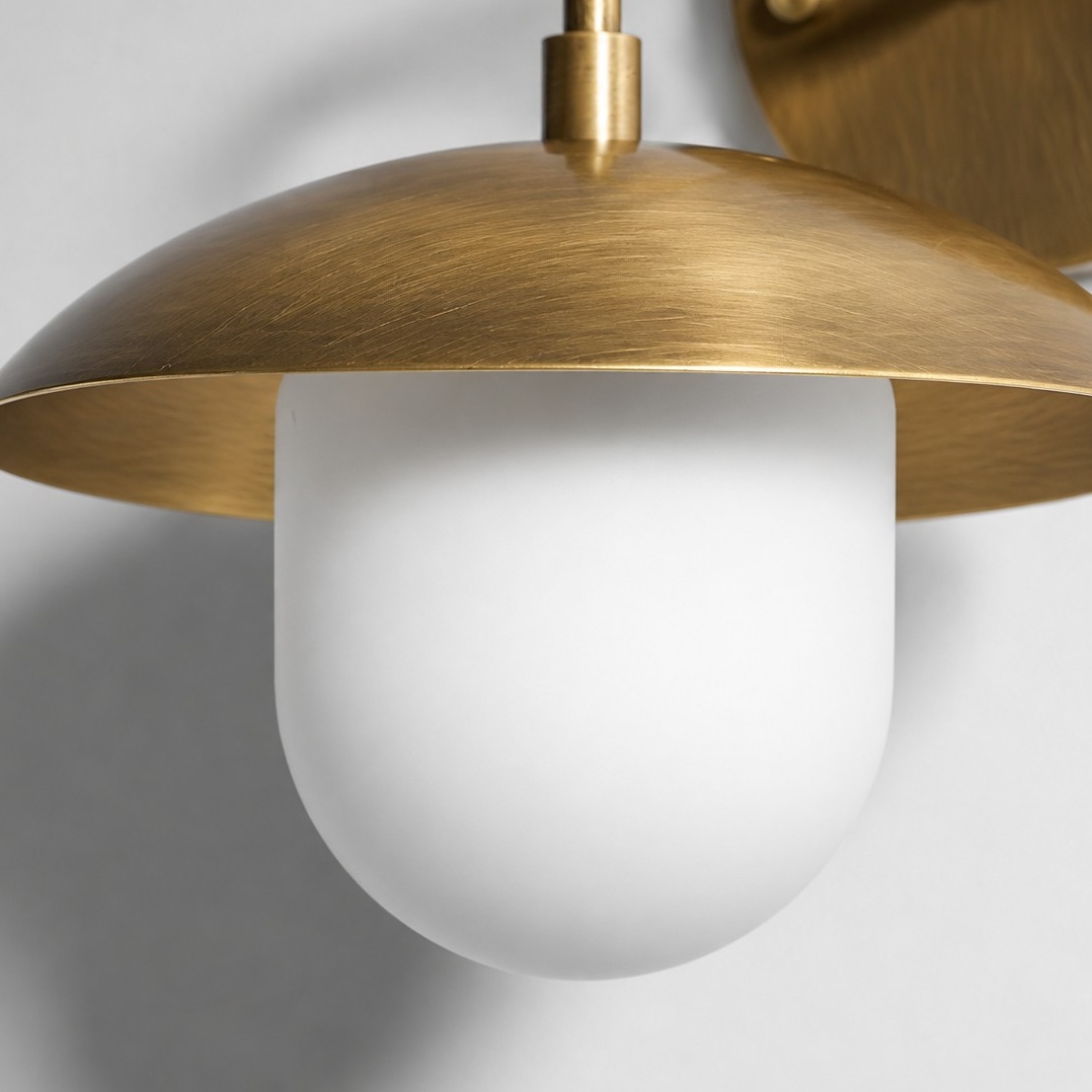 Frosted White Glass Globe — Brass-Finish Wall Sconce — A natural perspective