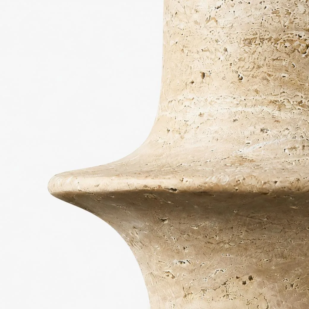 Close detail of polished travertine rim with natural pores and warm beige variation