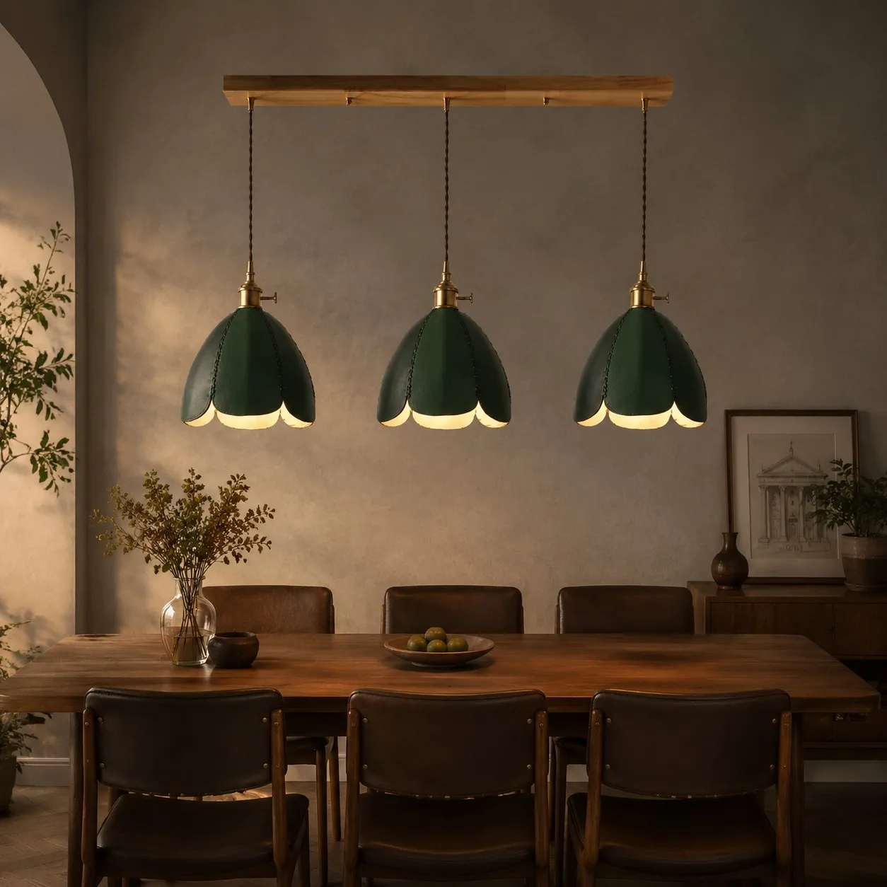 Three green leather pendant lights above a dining table