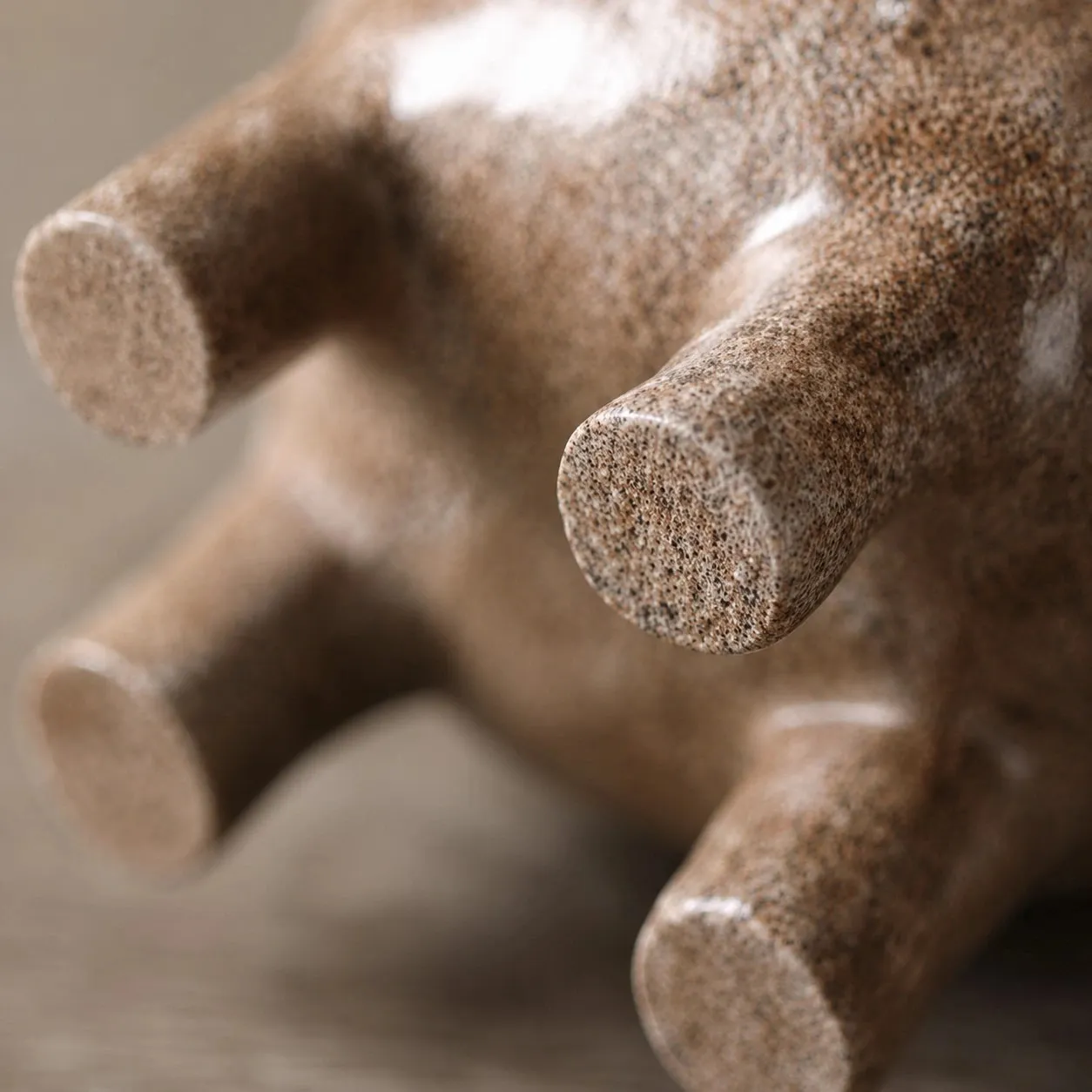 Close view of the rounded feet and speckled resin finish