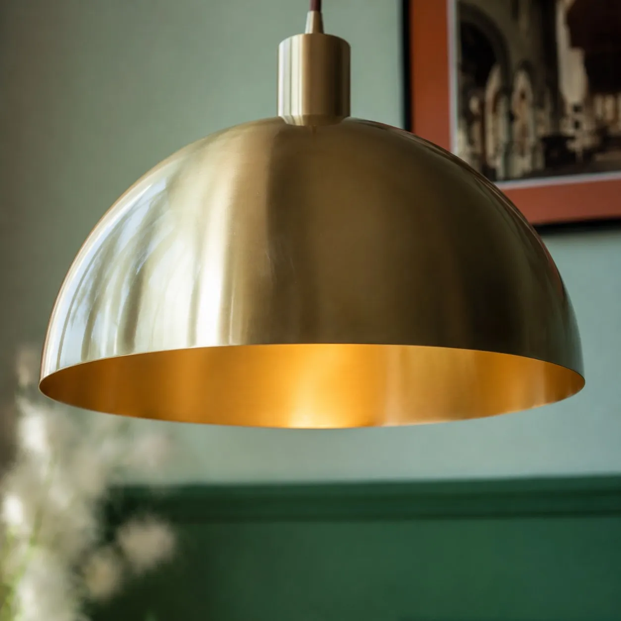 Close view of rolled brass shade edge and brushed texture
