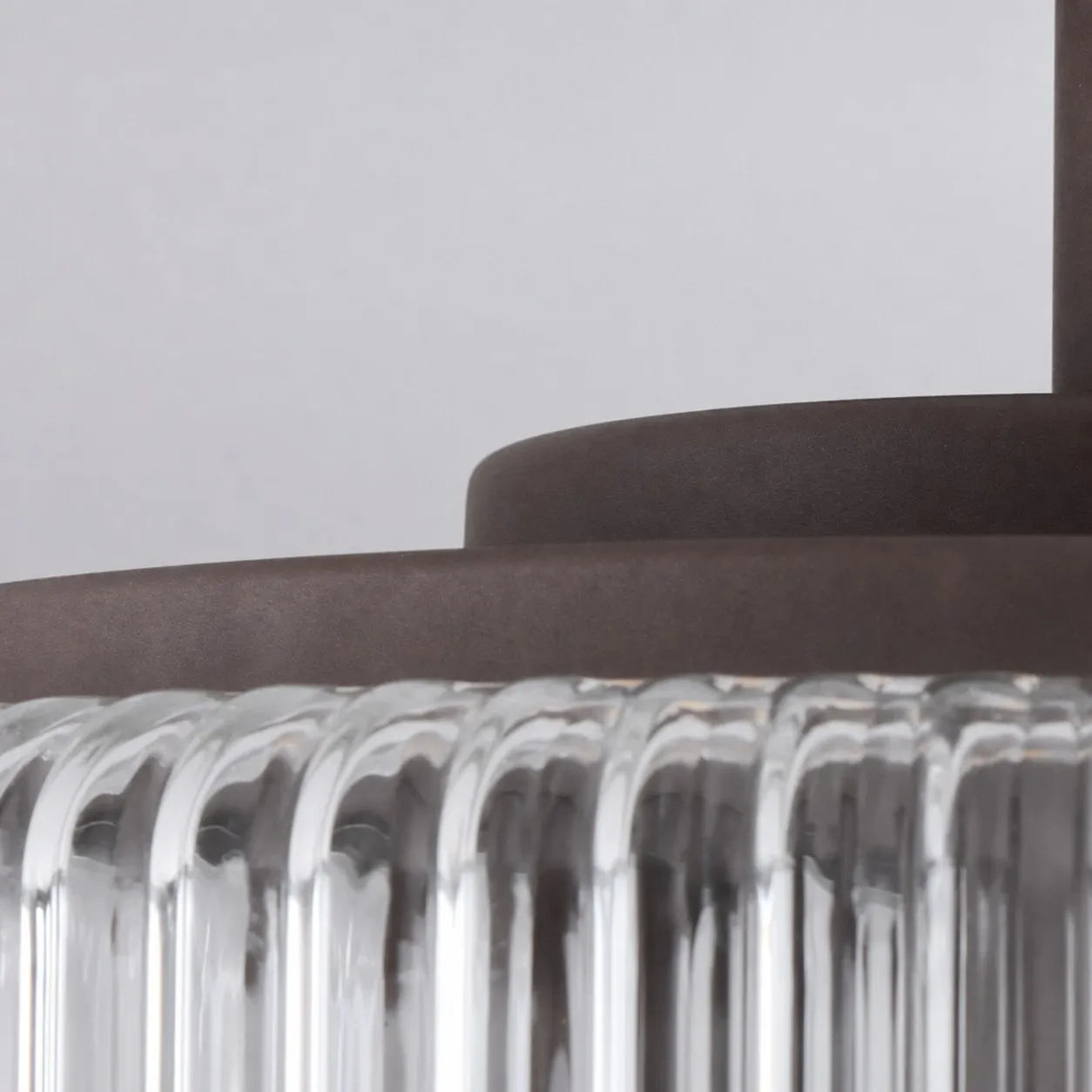 Close-up of metal canopy and ribbed glass edge