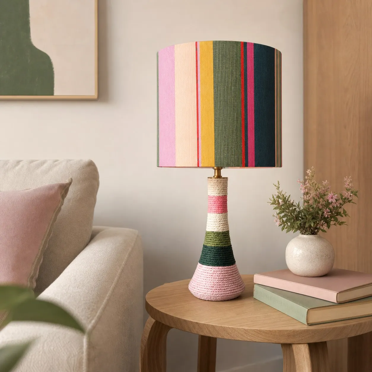 Colorful striped ceramic table lamp with cotton thread wrapped exterior in a cozy living room corner