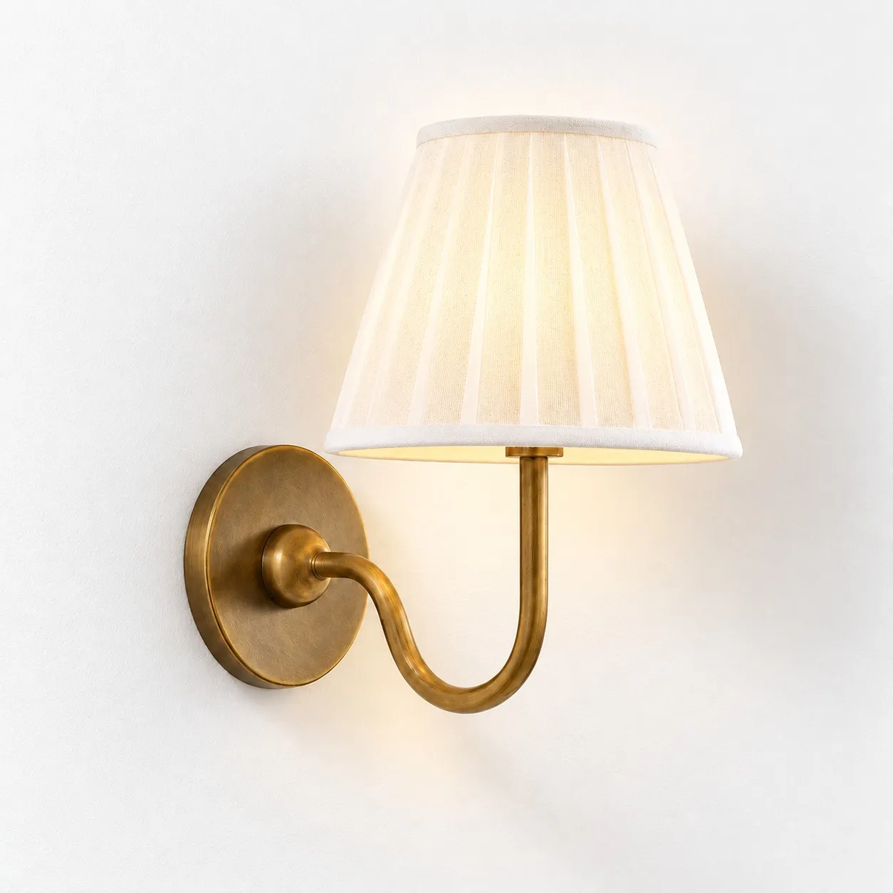 Luvora wall lamp with a lit white pleated shade