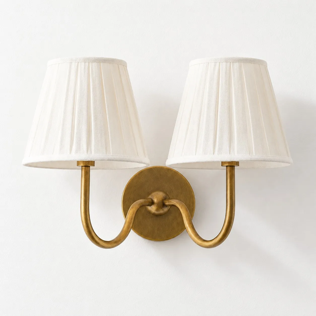 Two white pleated shades on one tumbled brass arm