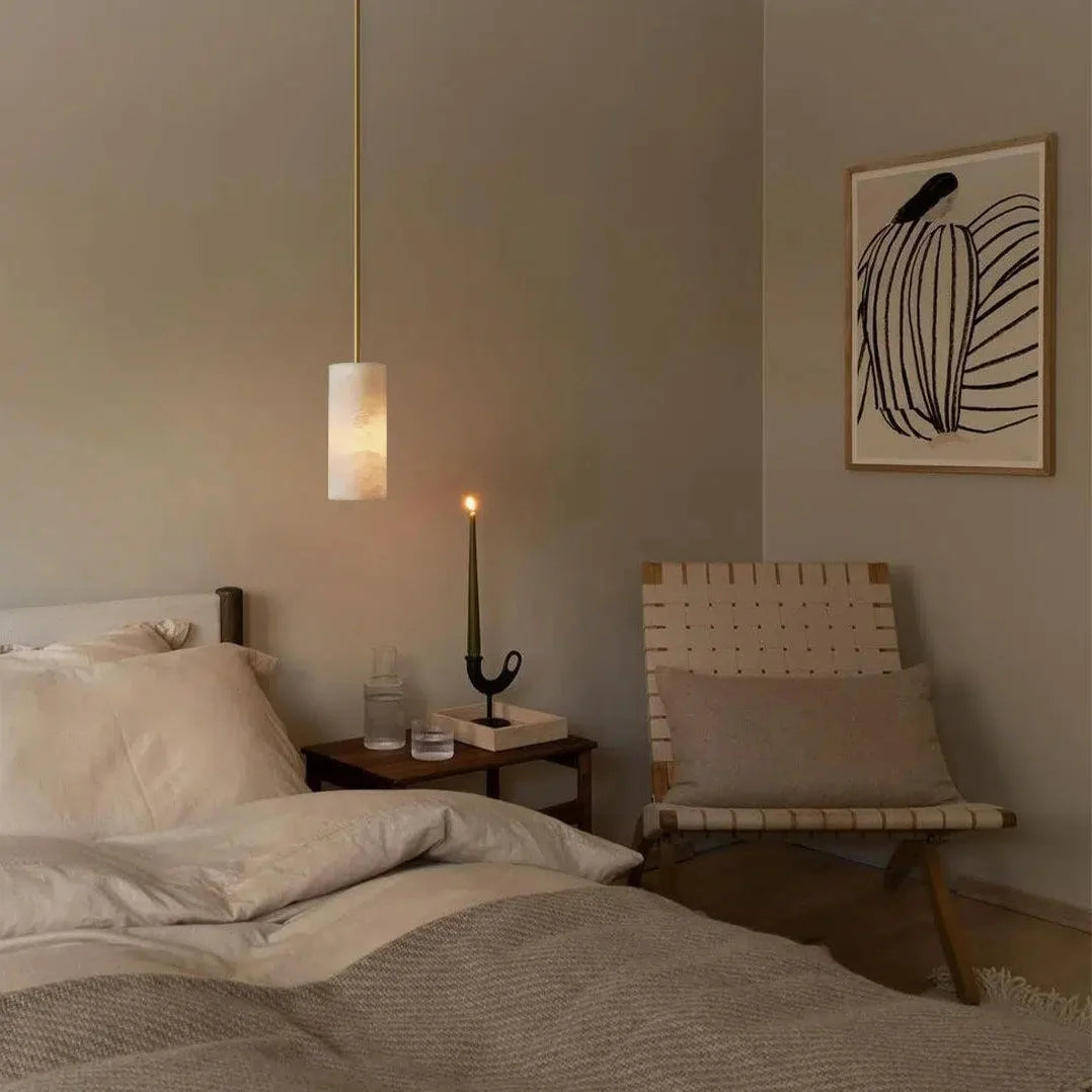Alabaster cylinder pendant light in a bedroom scene